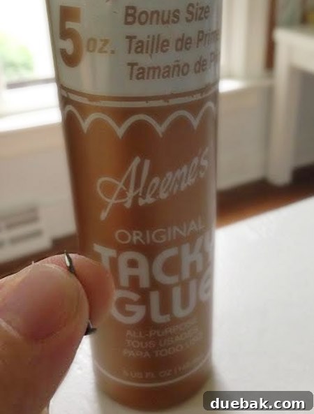 Applying Aleene's Tacky Glue to the back of a cork tile