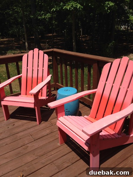Faded red Adirondack chairs in a backyard setting