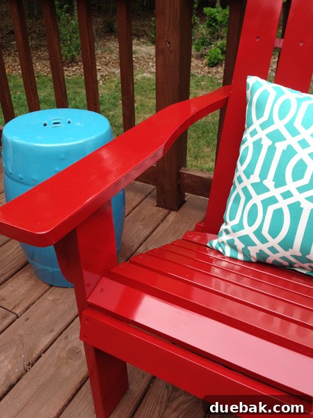 Bright red Adirondack chairs looking brand new after restoration