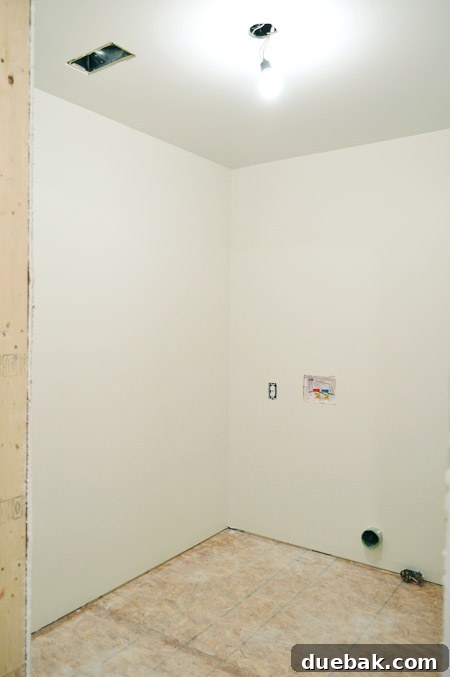 The newly painted laundry room in 'Going To The Chapel' by Benjamin Moore, appearing more finished and inviting.