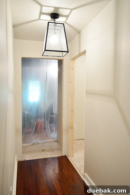 View of the newly painted hallway leading to the laundry room, showing continuity with existing walls.