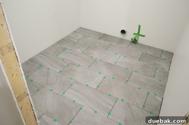 Newly tiled laundry room floor before grouting