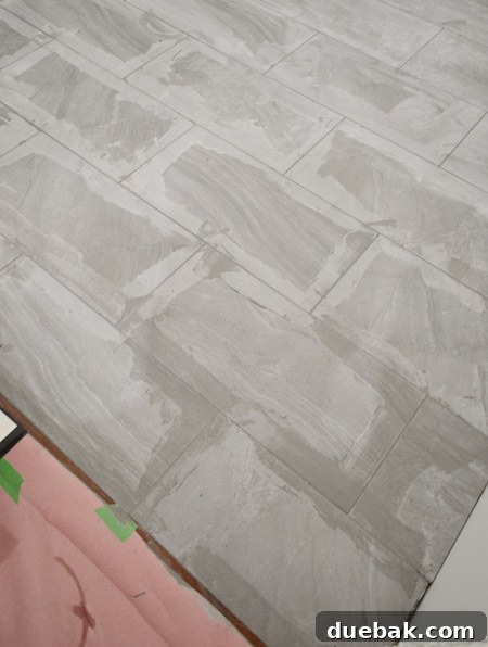 Grout drying and lightening on the tile floor