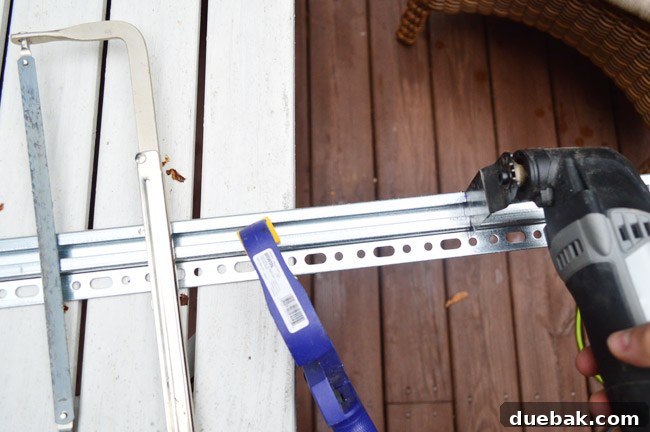Mastering Ikea Cabinet Installation 11 Cutting the IKEA metal hanging rail with a Dremel tool