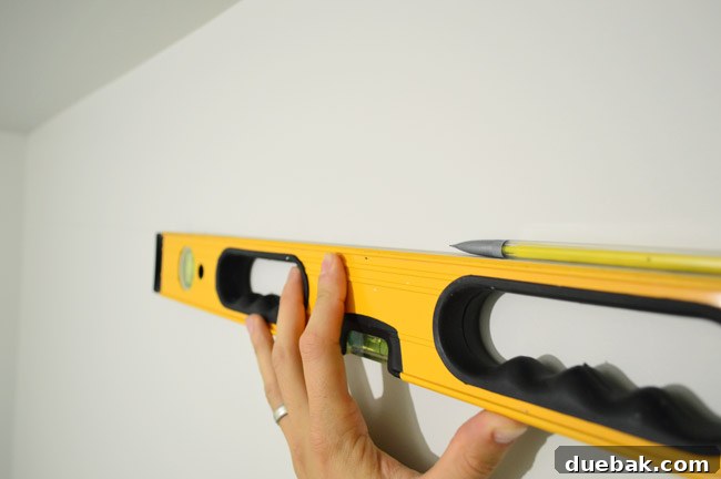 Mastering Ikea Cabinet Installation 13 Drawing a level line on the wall for cabinet rail placement