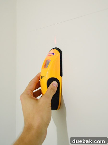 Mastering Ikea Cabinet Installation 16 Marked stud locations on the wall for secure cabinet rail mounting