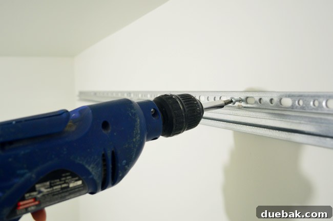 Mastering Ikea Cabinet Installation 17 The metal IKEA cabinet hanging rail securely mounted to the wall studs