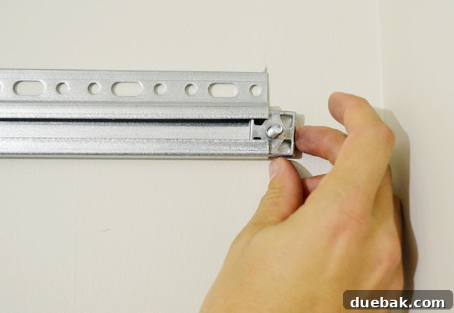 Mastering Ikea Cabinet Installation 18 Sliding bolts into the IKEA hanging rail to prepare for cabinets