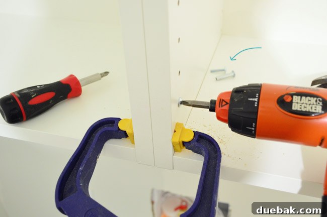 Mastering Ikea Cabinet Installation 22 Screwing two IKEA cabinet frames together to form a continuous unit