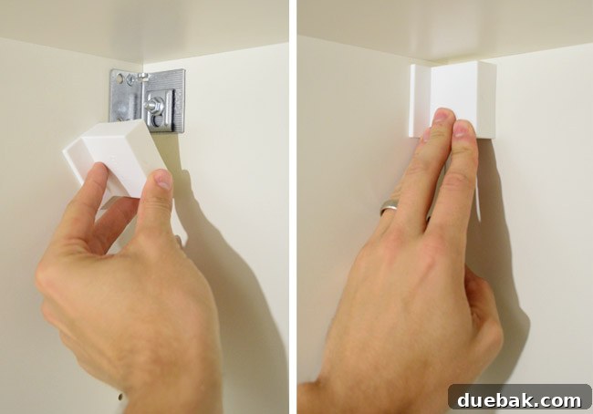 Mastering Ikea Cabinet Installation 23 Snapping on plastic caps to cover the hanging hardware on the back of the cabinet