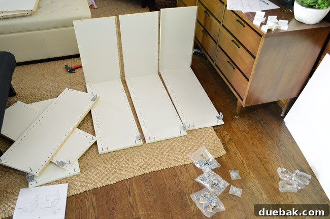 Mastering Ikea Cabinet Installation 8 Two people assembling IKEA cabinet frames on the floor