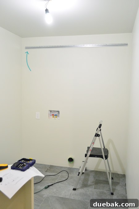 Mastering Ikea Cabinet Installation 10 Close-up of the IKEA metal hanging rail system on the wall