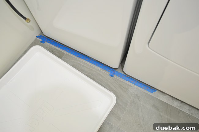Seamless DIY Waterfall Countertop 8 Floor marked with tape for washer pan placement
