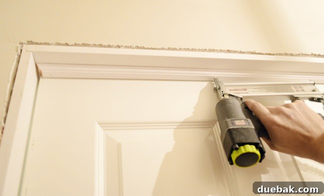 Nailing In Door Stop Trim Into DIY Jamb Kit Construction With Nail Gun