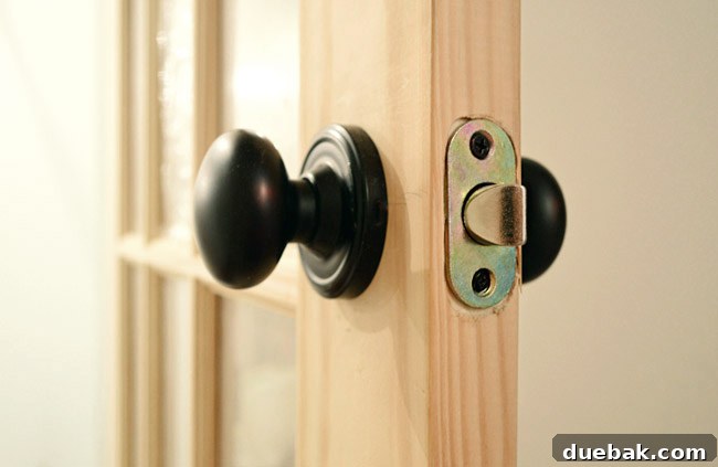 Oil Rubbed Bronze Door Knob Set Into Newly Created Holes In Unfinished Door