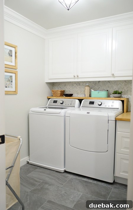 Bright and organized laundry room with white cabinets