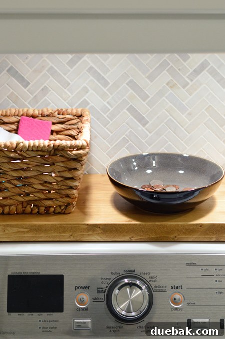Close-up of laundry room counter with mint green accessories