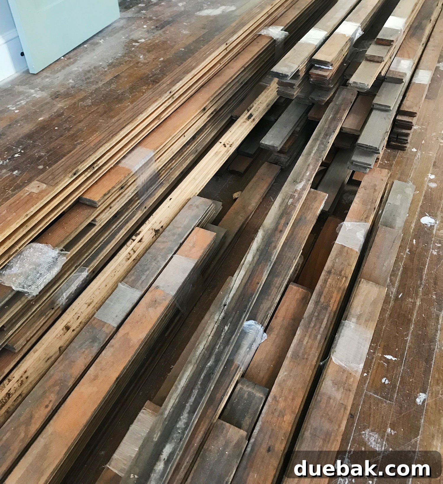 Revitalizing Hardwood Floors The Beginner's Handbook 10 Reclaimed wood boards carefully acclimating indoors before being installed as hardwood flooring