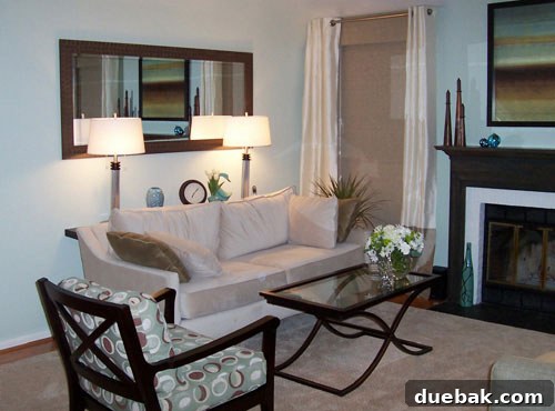 Close-up of Janis's newly designed living room with stylish glass coffee table and two-toned silk curtains