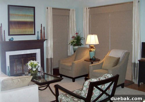 Another perspective of Janis's refreshed living room featuring a beautifully painted brick fireplace and modern decor