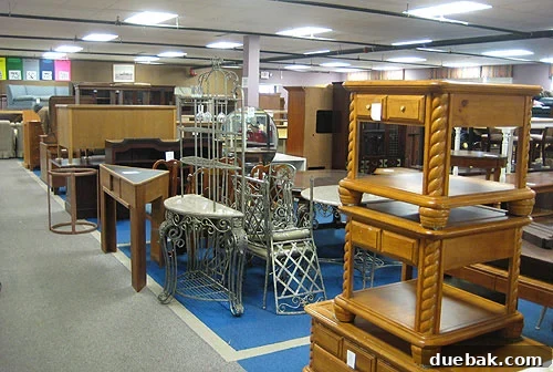 Interior view of Diversity Thrift showing a dense collection of various furniture pieces stacked high