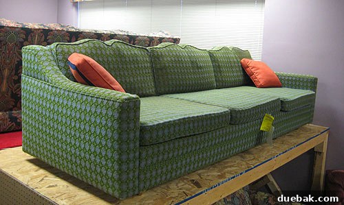 A charming blue and green patterned sofa with strong lines, found at Diversity Thrift, suitable for reupholstering