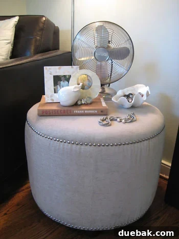 Nailhead and Linen Wheat-Colored Tan Ottoman from TJ Maxx Elegant linen-look ottoman with nailhead trim, a perfect budget-friendly addition to bedroom decor from TJ Maxx