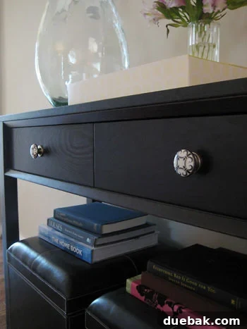 Effortless Installation of Anthropologie Knobs Close-up of new black and white Anthropologie knobs installed on a console table