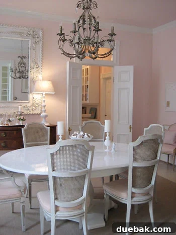 Formal dining room featuring a lacquered table and an elegant chandelier