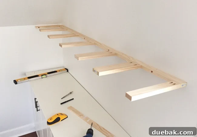 Brace piece of DIY thin wood floating shelves hung on a wall using 1x3 and 1x2 pine boards for support
