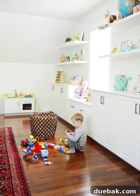 Bonus Room Glow Up 17 Child Playing with Legos by Organized Shelves in Bonus Room