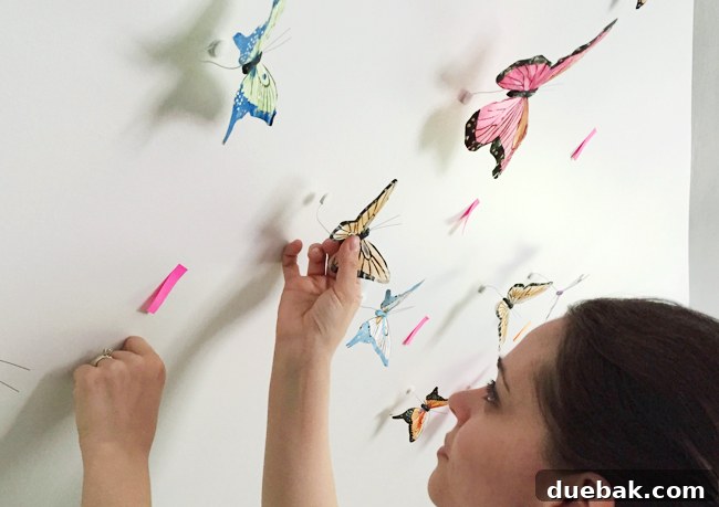 Bonus Room Glow Up 9 Hand Applying Decorative Butterflies to a Wall in a Bonus Room
