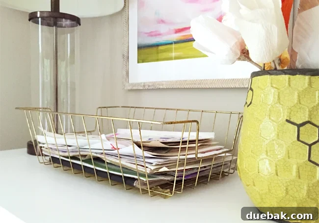 A stylish gold wire bin for organizing school papers and artwork, neatly containing documents.