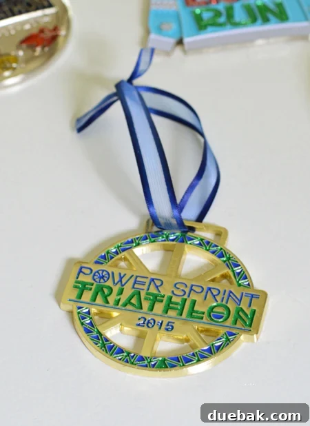 Cherished Miles, Festive Shine: Crafting Medal Ornaments 6 Triathlon race medal with newly attached shorter ribbon, ready to be hung on a Christmas tree