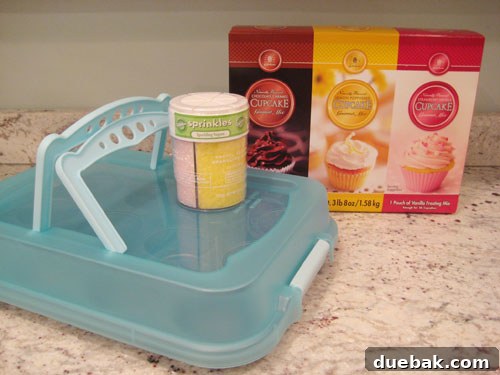 Assortment of charming cupcake-themed gifts, including a cupcake carrying caddy, colorful sprinkles, and gourmet cupcake mixes