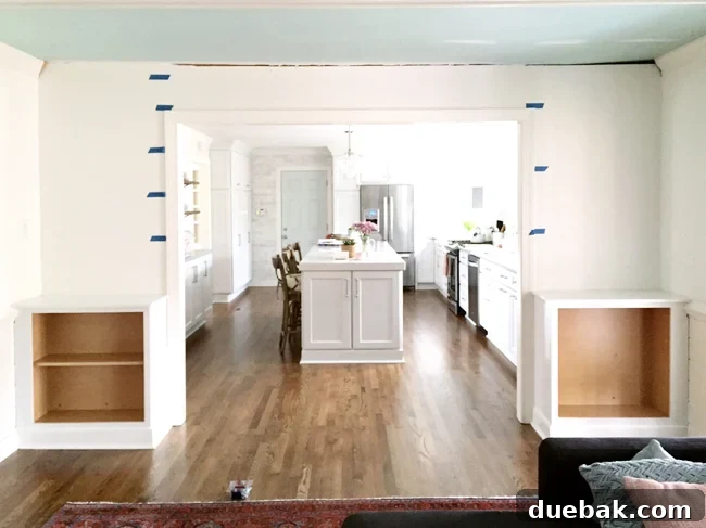 Tailored Book Nooks DIY Built Ins 8 Painters tape on the wall demonstrating two potential shelf spacing options for DIY built-in bookshelves