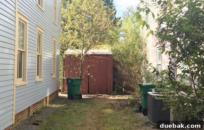 The old metal shed at the beach house, positioned closely to the main property, a source of renovation challenges