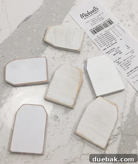 Selection of flat wooden tags purchased from a craft store, ready for customization.