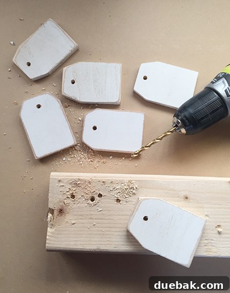 Wooden tags with newly drilled holes, ready for the next step in the ornament-making process.