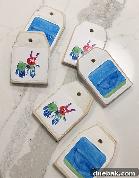 Another view of the wooden tag ornament with the child's caterpillar sticker art smoothly applied.