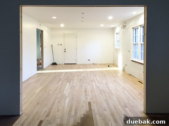 Hardwood floor installation nearing completion in the kitchen
