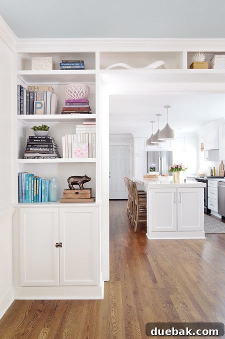 Seamless transition between new and old hardwood floors in living room and kitchen