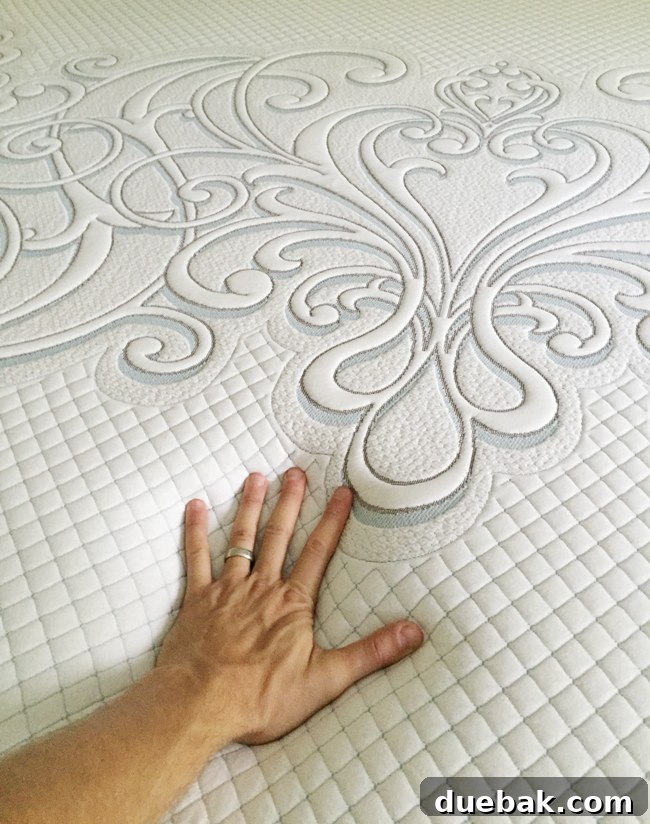 Woman testing the firmness of a Sealy Posturepedic Hybrid mattress by pushing down.