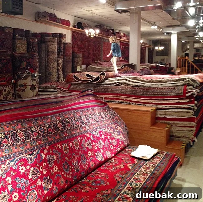 Interior of a rug store with stacks of traditional rugs