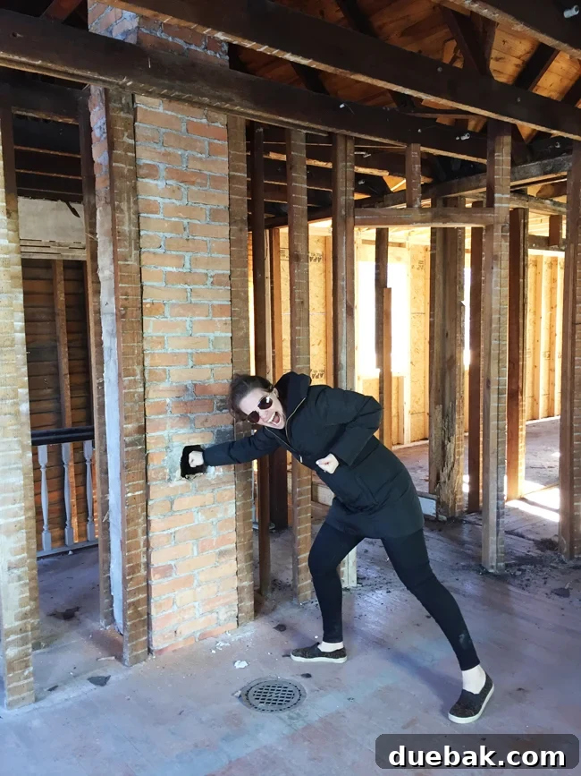 My Huge Beach House Overhaul and The Lessons of Rejection 6 Sherry playfully posing as Kung Fu Panda amidst renovation materials