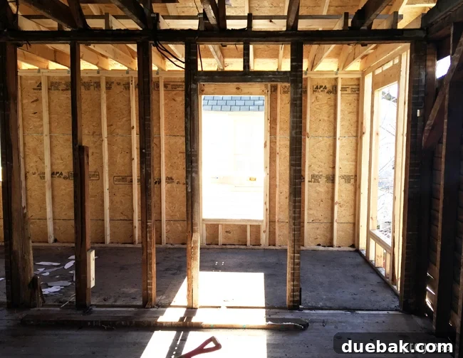 From Studs Up: The Beach House Revival 19 Interior view of the newly rebuilt bathroom area, showing solid new framing and a sense of openness.