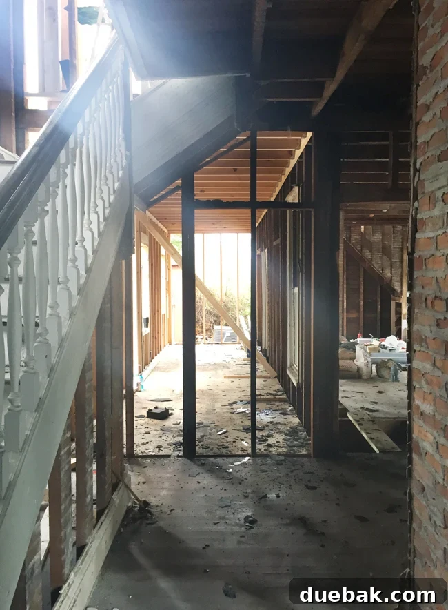 From Studs Up: The Beach House Revival 23 Downstairs view from the foyer towards the rebuilt section, showing a newly leveled floor and open space.