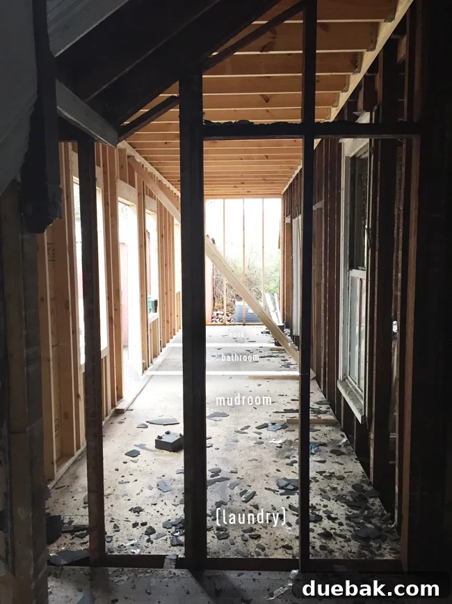 From Studs Up: The Beach House Revival 26 View of the future breakfast nook from the foyer, showing the framing and spatial relationship.