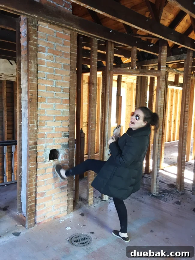 From Studs Up: The Beach House Revival 7 Blurry outtake photo of a person attempting a 'kicking' pose next to the newly discovered chimney.