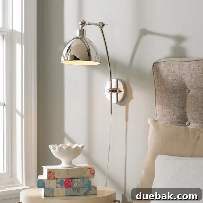 Final product photo of the chrome adjustable arm wall sconce in a staged bedroom